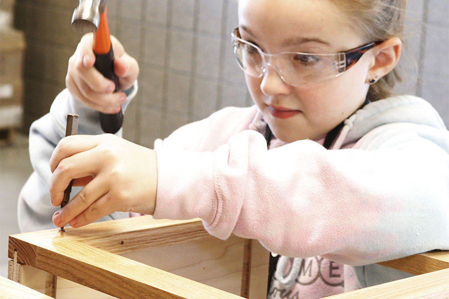 A 5th grade student building a cabinet and learning about the wood working industry.